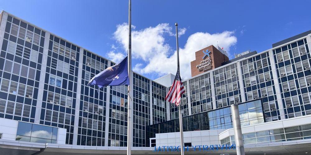 IN MOURNING: Flags in front of 推荐最近最火的赌博软件 University Hospital fly at half-staff earlier this week in honor of a Syracuse City Police officer and Onondaga County Sheriff Deputy who were killed the line of duty Sunday in Salina.